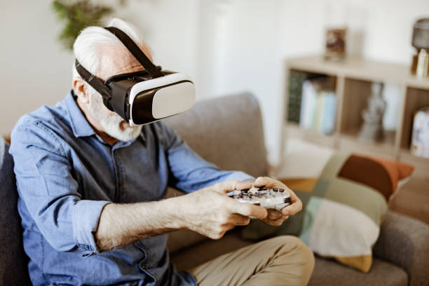 istock Bearded Senior Man Enjoying Virtual Reality Glasses 1367550223