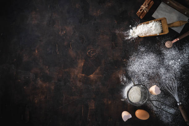 istock Bakery background with flour, eggs, sieve, whisk, serving scoop, cinnamon and Bench Scraper 1367551005