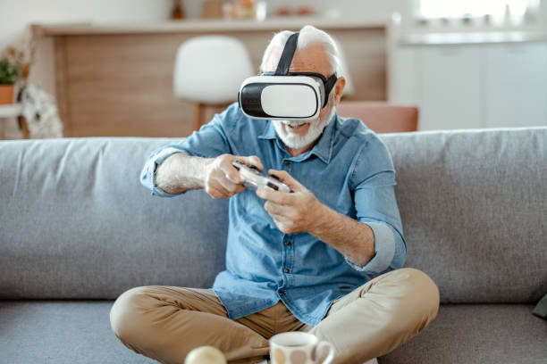 istock Bearded Senior Man Enjoying Virtual Reality Glasses 1367551313