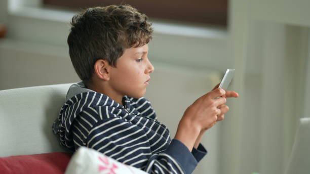 istock Young boy playing game with tablet. Child plays video-game on tech device 1367553210