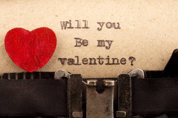 istock Will you be my Valentine? - phrase on typewriter. Valentines Day greetings concept. Little red wooden heart close up. Valentines greeting card. 1367554643