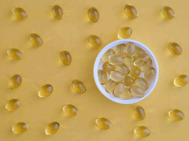Vitamin D3 softgels in a cap with other vitamin D3 softgels around them