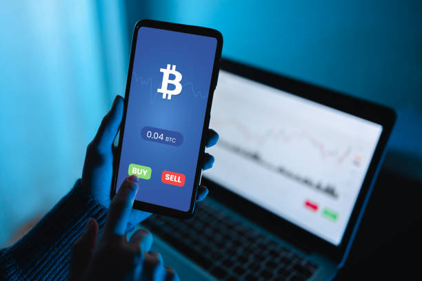 istock Trader using exchange crypto currency app using mobile phone - Stock market investor 1367559277