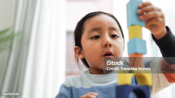 Young Asian Kid Playing With Color Blocks At Home Kindergarten Educational Games Focus On Boy Mouth Stock Photo - Download Image Now