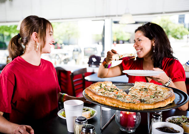 istock Family Eating Pizza at a Restaurant 136755977