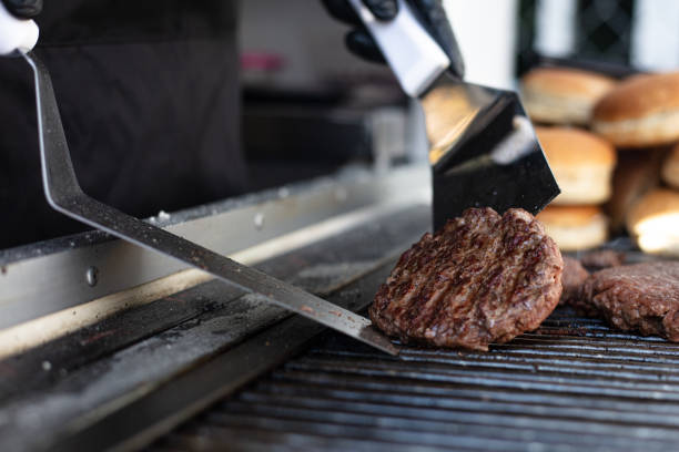 istock Hamburger meat on the grill 1367561286