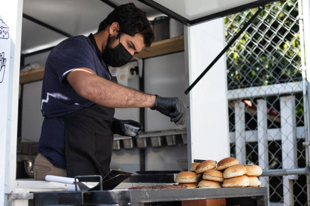 istock Chef seasoning and preparing hamburger 1367561289