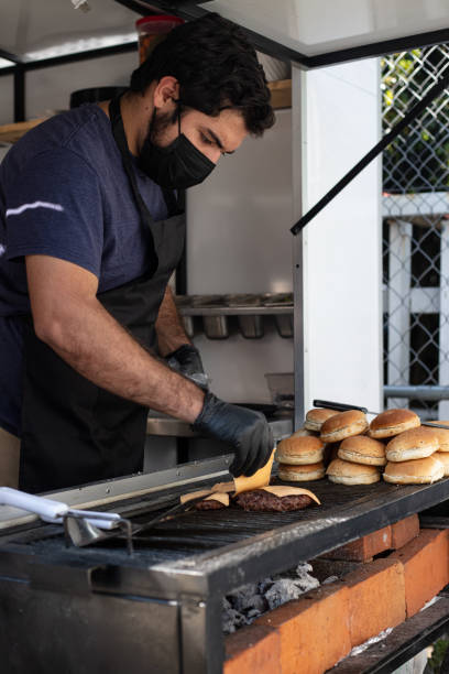 istock Chef seasoning and preparing hamburger 1367561974