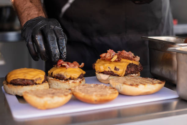 istock Chef preparing cheese burgers 1367562089