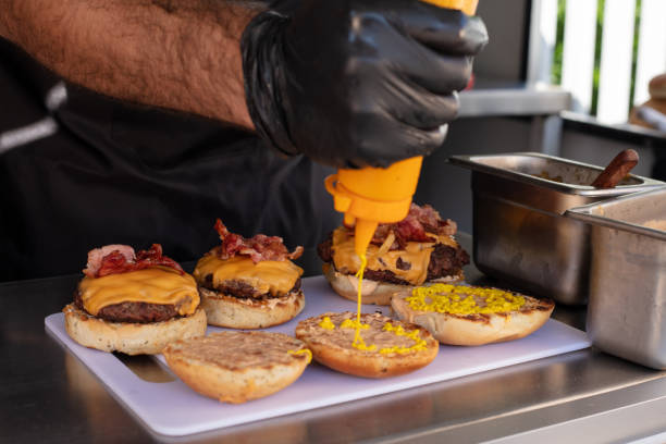 istock Chef preparing cheese burgers 1367562115