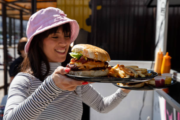 istock Woman about to eat burger 1367562276