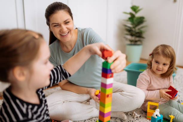 istock Mother and daughters playing and enjoying time together 1367563153