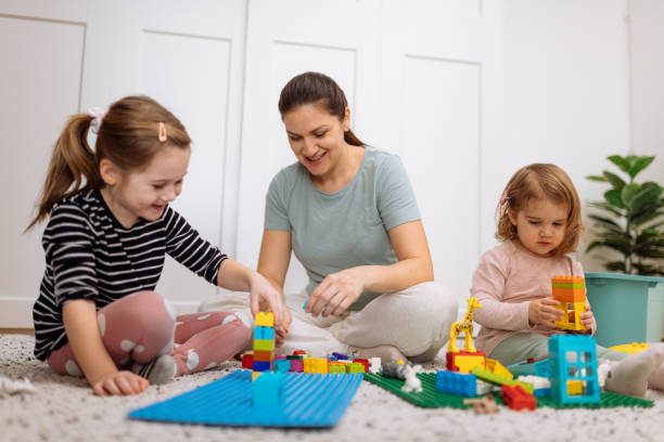 istock Mother and daughters playing and enjoying time together 1367563183