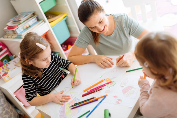 istock Mother and daughters playing, drawing and laughing 1367563206
