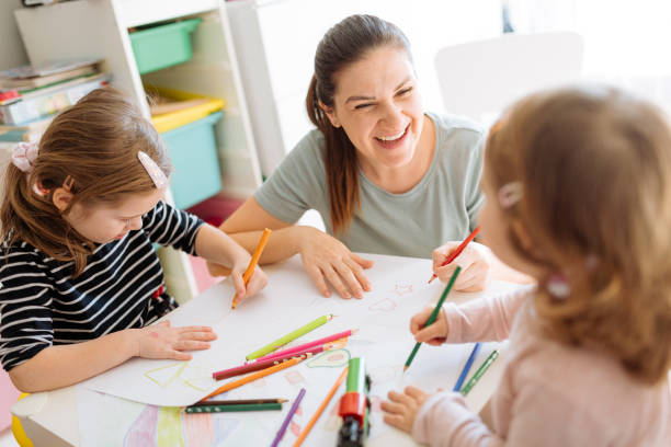 istock Mother and daughters playing, drawing and laughing 1367563217