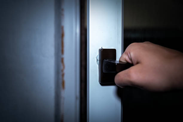 istock Male hand opens the window at night 1367565328