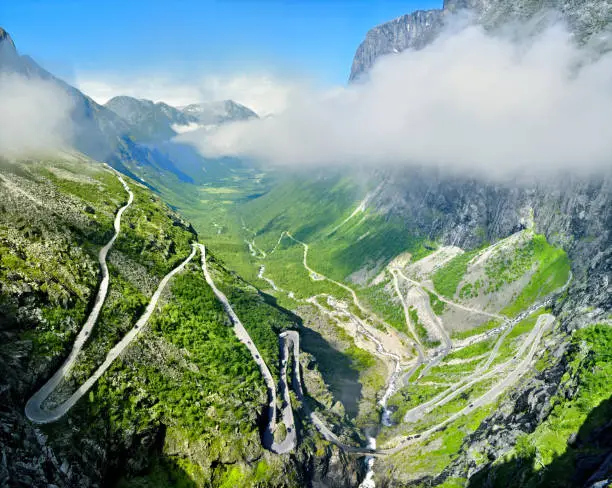 Photo of Troll road, Norway - Narrow winding road through mountains and valleys. Summer weather, clouds around the rocks.