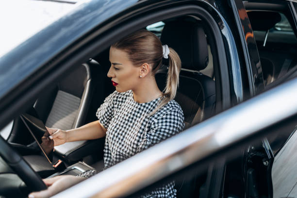istock Female used car dealer checking vehicle before customer 1367569421