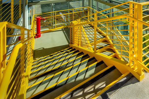 Beautiful and simple background image of  staircase for public. Interior architecture of public staircase with handrail made by steel pipe.