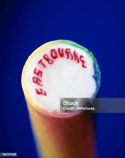 Colourful Stick Of Rock From Eastbourne On Vibrant Blue Background Stock Photo - Download Image Now