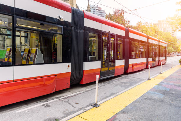 istock Electric tram leaving a stop in a downtown 1367575089