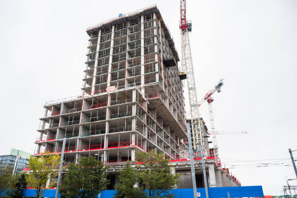 istock Building in construction in a downtown district on a cloudy autumn day 1367575101