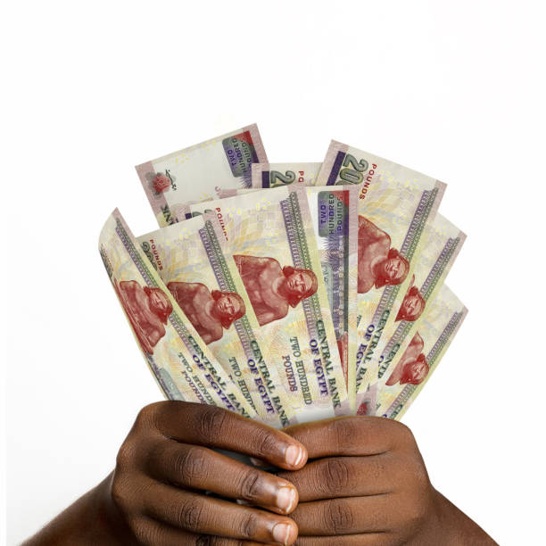istock Black hands holding 3D rendered 200 Egyptian pound notes. closeup of Hands holding Egyptian currency notes 1367578829