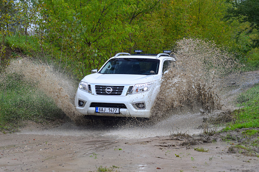 Zdiar, Slovakia - 24th September, 2017: Nissan NP300 Navara driving through a puddle. The Navara is one of the most popular pickups in Europe.