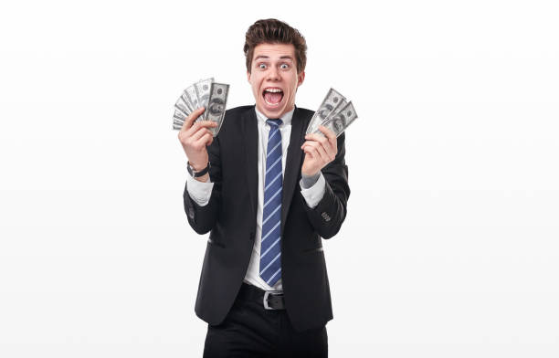 istock Excited young businessman with money 1367581721