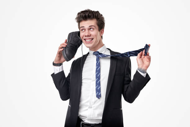 istock Crazy businessman using shoe as phone 1367581746