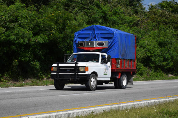 Cancun, Mexico - 11 January, 2018: Classic Ford F-250 (1986-1991) driving on a highway. This model was a very popular pick-up vehicle in North America in 80s and 90s.