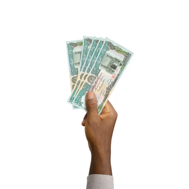 istock Black Hand holding 3D rendered Afghanistan afghanis notes isolated on white background 1367587183