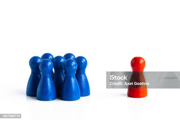 Group Of Game Pieces With One Outsider Stock Photo - Download Image Now - Exclusion, Meeting, Disability