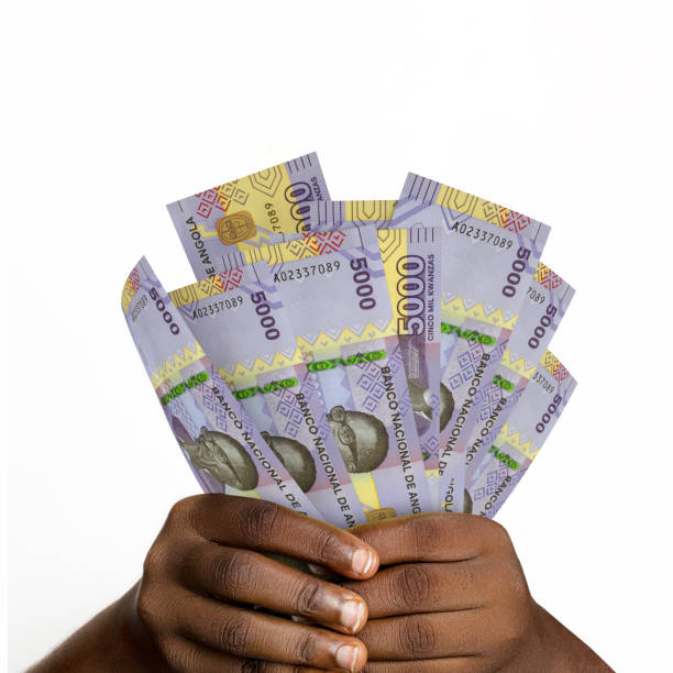 Black hands holding 3D rendered 5000 Angolan kwanza notes. closeup of Hands holding Angolan currency notes Black hands holding 3D rendered 5000 Angolan kwanza notes. closeup of Hands holding Angolan currency notes angolan kwanza photos stock pictures, royalty-free photos & images