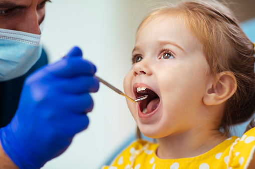 Young girl having a routine checkup at the dentist