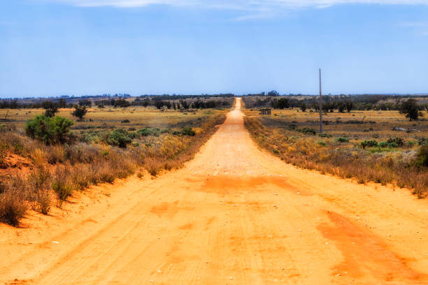 Unsealed red soil dirt road in outback of Australia - Lake Mungo national park.