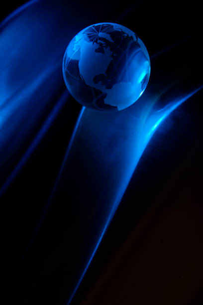 This is a close up photo of a glass transparent glow on a sheet of Metal that creates an area a black background for copy space. The focus is on America. The lighting is blue creating a cool effect