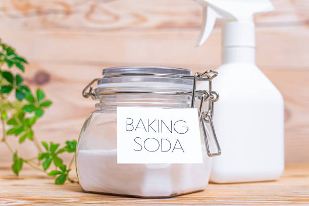 istock Baking soda in container on wooden background. 1367596914