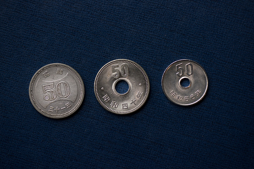 Close-up of old and new 50-yen coins in Japan