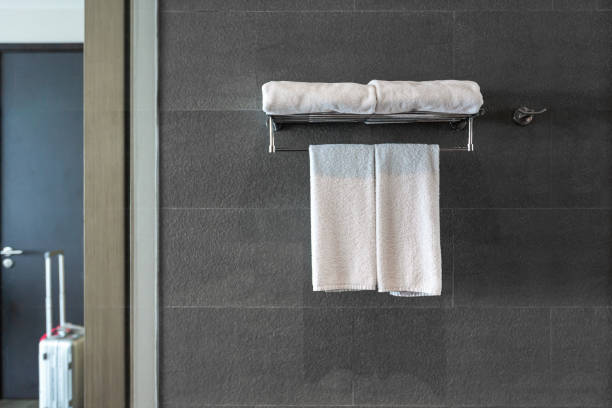 istock Hanger with clean towels on brick wall in bathroom. 1367603166