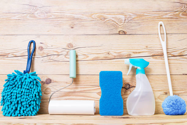 istock Cleaning tools on wooden background. 1367603251