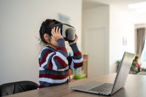 istock A little girl is at home playing with a virtual reality headset 1367610397