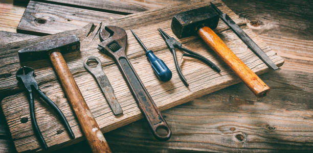 istock Work tool old used on wood table. Construction industry, carpentry vintage equipment, overhead 1367614600