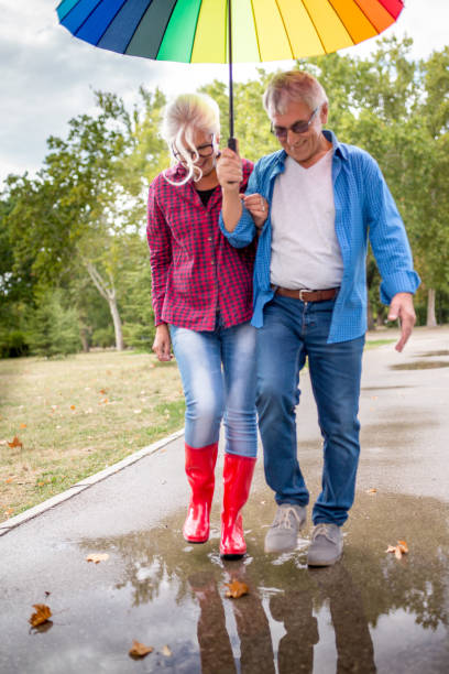 istock Couple walking in wet day 1367616197
