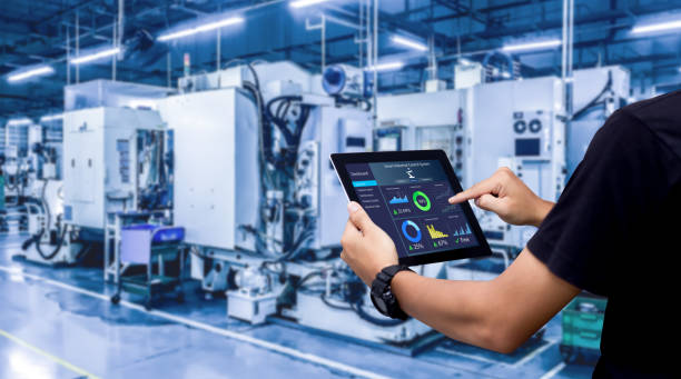 Smart industry control concept. Hands holding tablet on blurred automation machine as background smart stock pictures, royalty-free photos & images