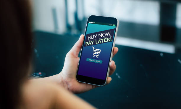 BNPL Buy now pay later online shopping concept. Hands holding mobile phone wages stock pictures, royalty-free photos & images