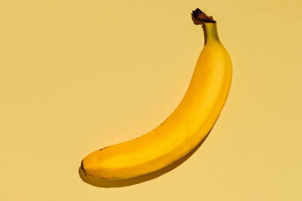 istock Yellow ripe banana on a bright yellow background. fruit background idea 1367618964