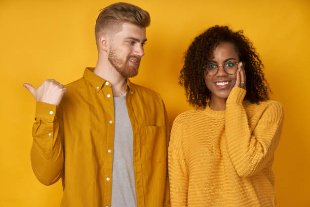 istock Woman hears advice from boyfriend who tells something, points aside with thumb 1367620992