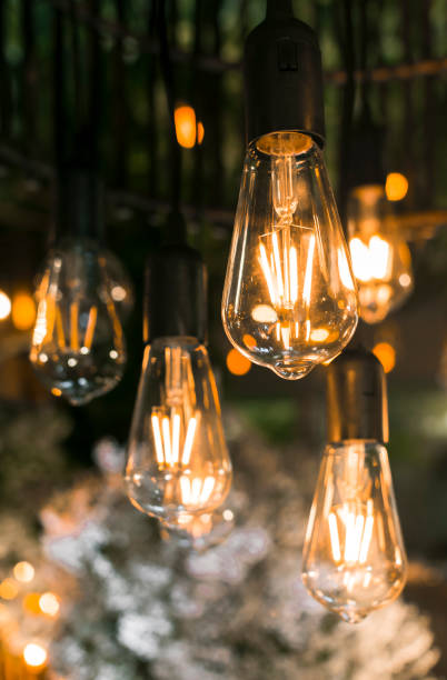 istock Beautiful warm incandescent led string light used as part of ceiling decor at a wedding reception. Shallow focus area. Background image. 1367623816