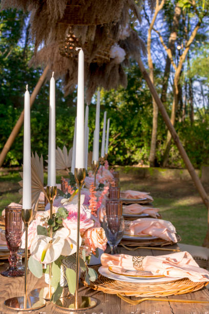 istock A beautiful rustic table setup at an outdoor garden wedding. White tall candles. Open-air banquet, outside 1367624051